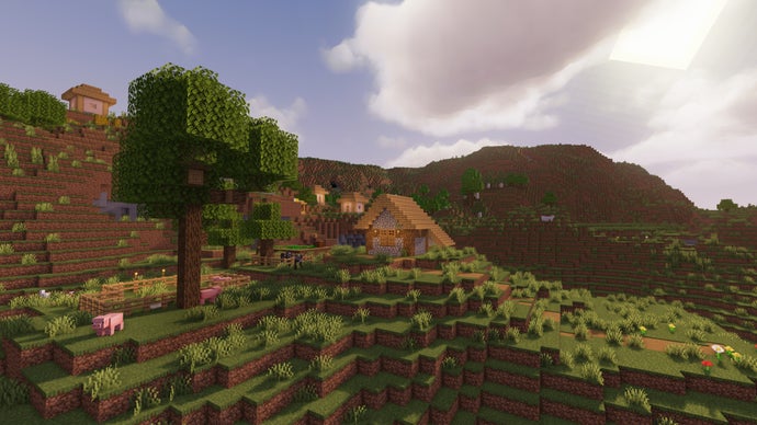 Uma paisagem de colinas extremas no servidor Minecraft, com uma árvore em primeiro plano e uma vila ao fundo.